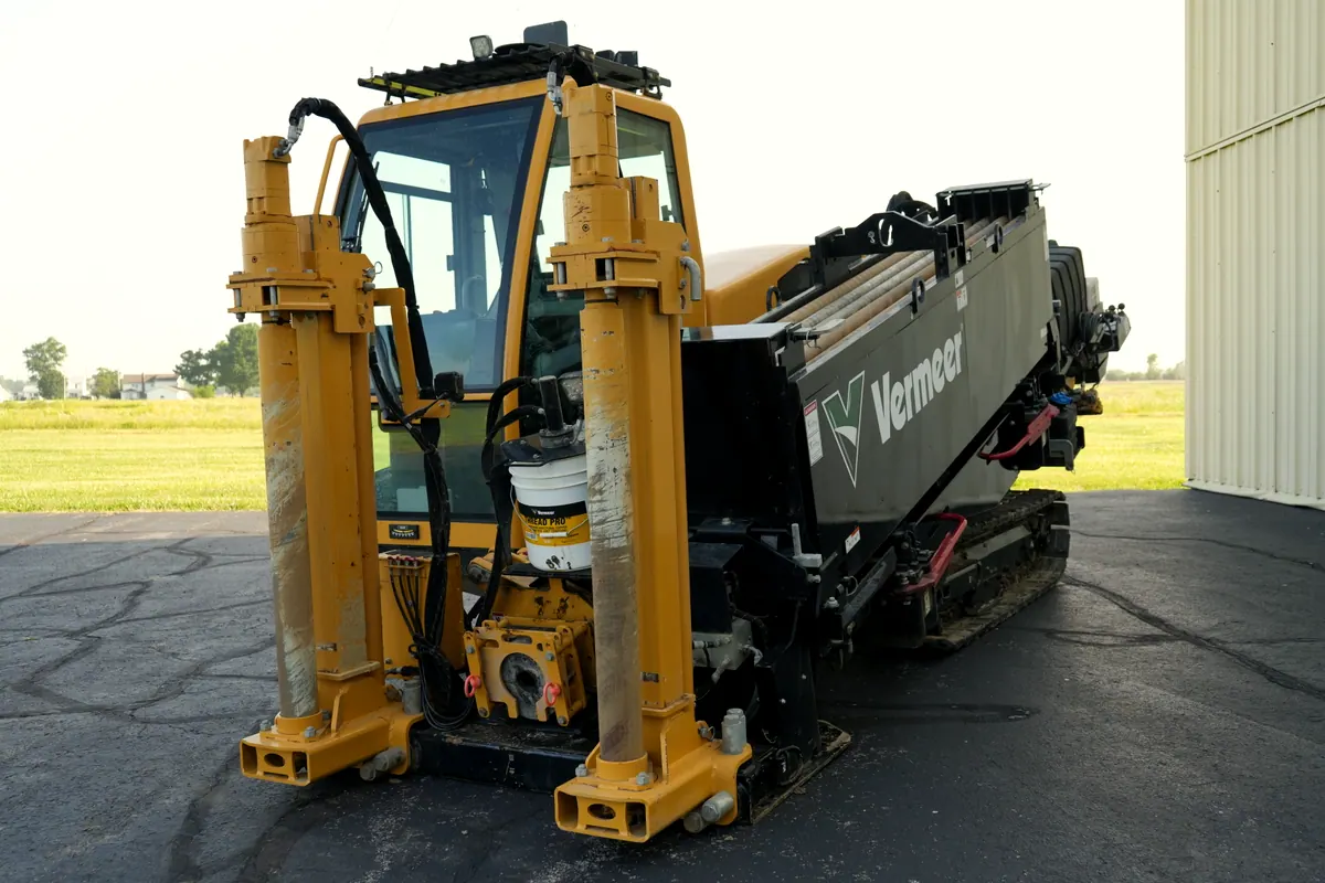 The Vermeer D24x40 S3 directional drill parked in the yard, anchor stakes down and the rod box loaded.