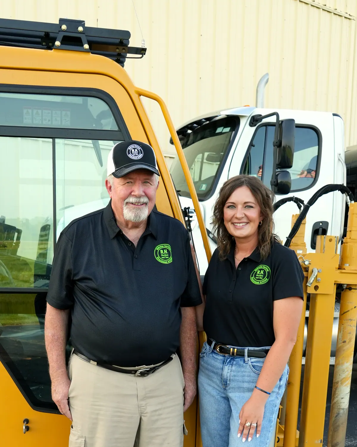 Rich and Lindsay Hollar standing in front of the Vermeer directional drill.